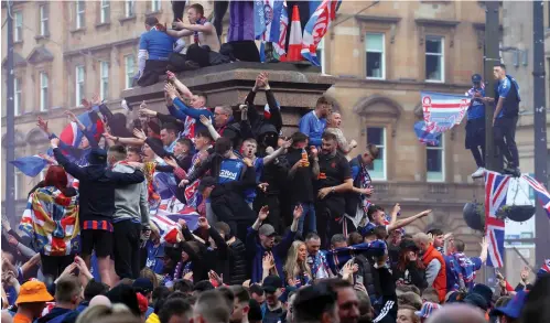  ?? Picture: Andrew Milligan ?? Rangers fans gather on a statue plinth in George Square, Glasgow, on Saturday