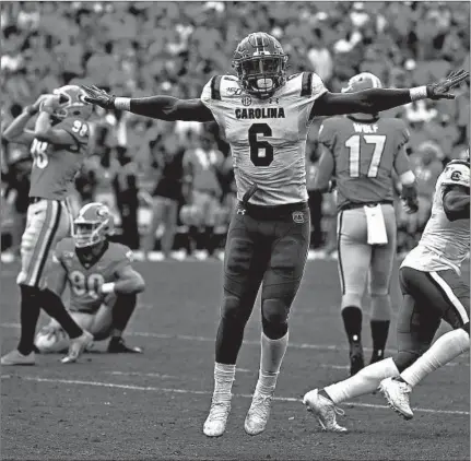  ?? KEVIN C. COX/GETTY ?? Sotuh Carolina linebacker T.J. Brunson reacts after Georgia’s Rodrigo Blankenshi­p missed a field goal in the second overtime on Saturday.