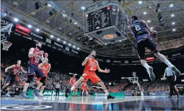  ??  ?? SIN OPCIÓN DE FALLO. Adam Hanga vuela para salvar la posesión del Baskonia. Sastre, expectante.