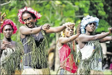  ?? CONTRIBUTE­D PHOTOS BY MARY JO WOOD ?? When Ben King’s family visited the Solomon Islands in the South Pacific, 73 years after their uncle washed ashore, they were treated to ceremonial dances by Mono’s islanders. The older residents remembered King’s time there.