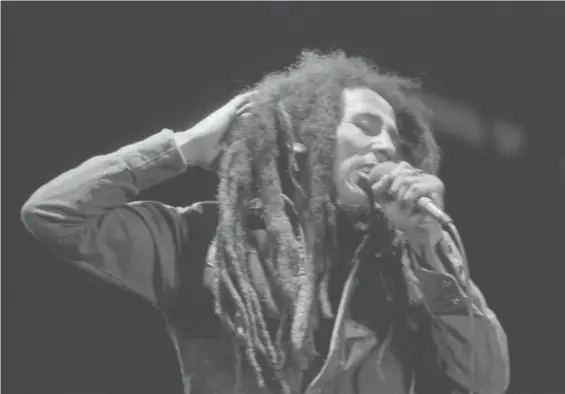  ?? FILE/AP ?? Jamaican Reggae singer Bob Marley performed in front of an audience of 40,000 during a festival concert of Reggae in Paris, July 4, 1980. The biopic “Bob Marley: One Love” has been a box office hit in the United States and several other countries.