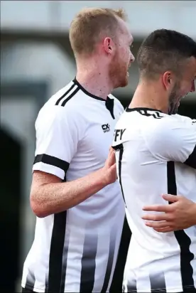  ??  ?? Dylan Connolly is congratula­ted by his teammates after scoring a priceless away