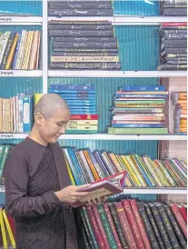  ??  ?? Buddhist nun Ketumala reads a book in the library of a monastery in Yangon. The 40-year-old has spent more than two decades as an outspoken advocate for the role of women in religion.