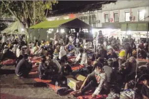  ?? ?? Wounded survivors of an earthquake are being treated in the yard of a hospital in Cianjur on Monday.