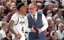  ?? AP PHOTO/SAM CRAFT ?? Texas A&M men’s basketball coach Buzz Williams talks with guard Wade Taylor IV during last Saturday’s home win against Alabama.