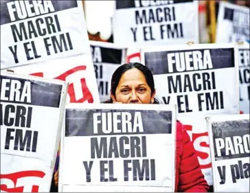  ?? RONALDO SCHEMIDT/AFP ?? People protest in Buenos Aires, Argentina last month against President Mauricio Macri’s economic policies.