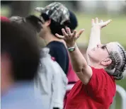  ?? MATIAS J. OCNER mocner@miamiheral­d.com ?? A President Trump supporter prays before the start of a campaign rally near the Cuban Memorial Monument.