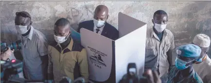  ?? Photo: Nampa/AFP ?? New era… Central African Republic President Faustin Archange Touadera (second from right, back) is seen at a voting booth surrounded by the presidenti­al guard.