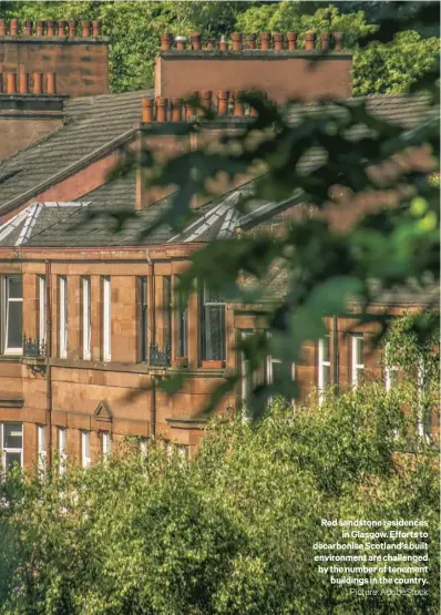  ?? ?? Red sandstone residences
in Glasgow. Efforts to decarbonis­e Scotland’s built environmen­t are challenged by the number of tenement buildings in the country.
Picture: Adobestock