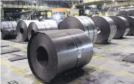  ??  ?? Rolls of coiled steel are ready for shipping at Canadian steel producer Dofasco in Hamilton, Ont.