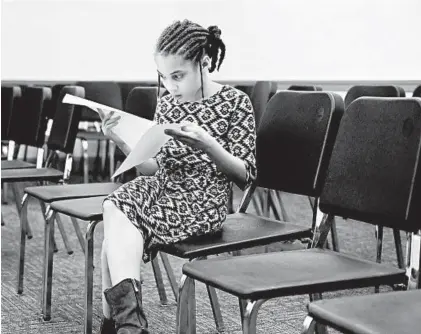  ?? KIM HAIRSTON/BALTIMORE SUN ?? Zoe McFadden, 10, of Mount Washington looks over sheet music for “My Country ’Tis of Thee” before her vocal music audition at Baltimore School for the Arts as she seeks a place in TWIGS.