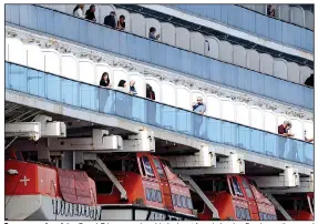  ?? (AP/Noah Berger) ?? Passengers aboard the Grand Princess cruise ship look out from balconies Sunday as the vessel maintains a holding pattern about 25 miles off the coast of San Francisco.