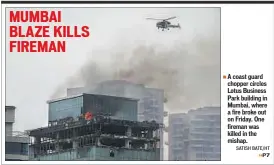  ?? SATISH BATE/HT ?? A coast guard chopper circles Lotus Business Park building in Mumbai, where a fire broke out on Friday. One fireman was killed in the mishap.