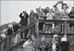  ?? AP/TIM SHORTT ?? Spectators gather Friday at Pineda Beach, across from Patrick Air Force Base to watch Friday’s NASA liftoff in Cape Canaveral, Fla.