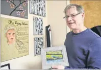  ?? NIKKI SULLIVAN/CAPE BRETON POST ?? Tom MacNeil, a social worker at the Cape Breton Cancer Centre, stands in his office, shows off some of the art that was made during some art therapy workshops offered through the centre. He is the one who pushed to start the Cape Breton Cancer Fund and...