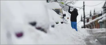  ?? BEN HASTY — READING EAGLE ?? A man clears snow from his car on Chestnut Street in West Reading on Tuesday, Feb. 1, 2021, after a nor’easter dumped heavy snow on Berks County.