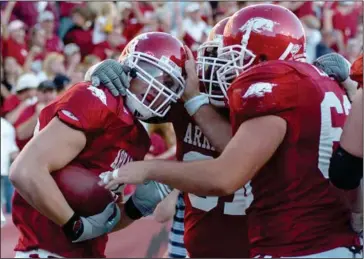  ?? (Arkansas Democrat-Gazette file photo) ?? Arkansas freshman tight end Ben Cleveland (left) is congratula­ted by teammates after catching the winning touchdown in the second overtime of the Razorbacks’ 24-23 victory over Alabama on Sept. 23, 2006.