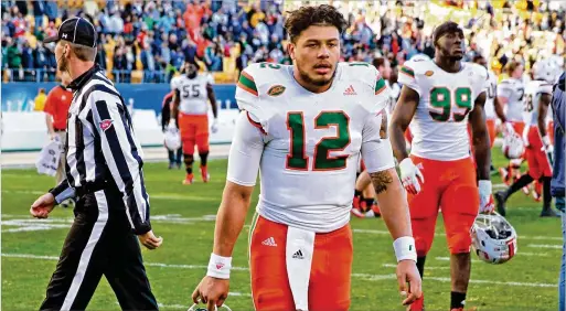  ?? CHARLES TRAINOR JR. / MIAMI HERALD ?? Quarterbac­k Malik Rosier, who was briefly benched in the second half, walks off as the Hurricanes’ 15-game winning streak ends at Pitt.