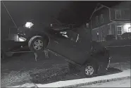  ?? PHOTO COURTESY OF FIRE BATTALION CHIEF MARK WATERS ?? New London police found this vehicle partly suspended on a utility pole guidewire when they responded to an accident at Jefferson Avenue and Boulder Drive.