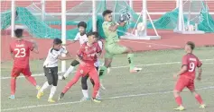  ??  ?? Sarawak players (in red) attack the Terengganu goalmouth at Miri Stadium yesterday.
