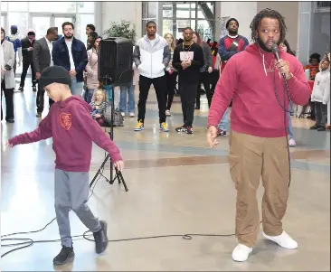  ?? ED BOOTH — ENTERPRISE-RECORD ?? Christen Brown, right, whose stage name is G'Riot, performs a rap with the theme of ending gun violence; his 9-year-old son, Eliyah, dances to the beat, at the Victory in Unity rally at Bell Memorial Union in Chico on Sunday.