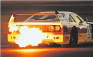  ??  ?? Ferrari F40 spits flames in the Endurance Legends race.