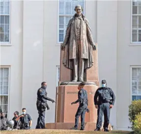  ?? MICKEY WELSH/USA TODAY NETWORK ?? Police officers patrol the Alabama state Capitol on Jan. 17. The statue depicts former Confederat­e leader Jefferson Davis.