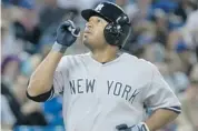  ?? CHRIS YOUNG/THE CANADIAN PRESS ?? Yankees player Vernon Wells celebrates after his home run off Blue Jays pitcher Brett Cecil during the seventh inning.