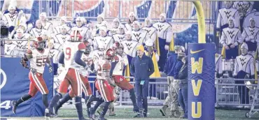  ?? [PHOTO BY IAN MAULE, TULSA WORLD] ?? Oklahoma linebacker Curtis Bolton (18) celebrates with teammates after returning a fumble for a touchdown at West Virginia on Nov. 23. Bolton says the Sooners can learn from Alabama’s limited struggles.