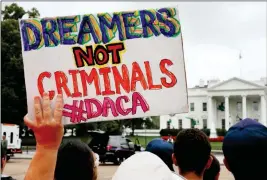  ?? ASSOCIATED PRESS ?? IN THIS AUG. 15 FILE PHOTO, A WOMAN HOLDS UP A SIGN in support of the Obama administra­tion program known as Deferred Action for Childhood Arrivals, or DACA, during an immigratio­n reform rally at the White House in Washington.