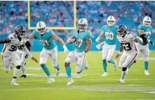  ?? MICHAEL LAUGHLIN/SUN SENTINEL ?? Dolphins running back Myles Gaskin gains a first down against the Falcons during the first half of Saturday night’s game.