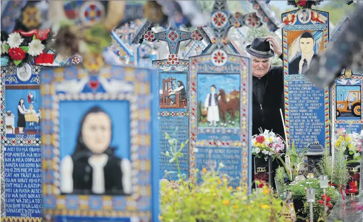  ?? PHOTOS: VADIM GHIRDA/THE ASSOCIATED PRESS ?? Graves at the Merry Cemetery in Romania are decorated with colourful epitaphs and childlike drawings.