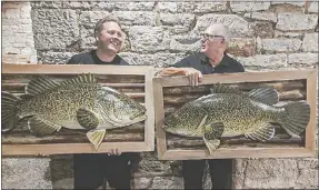  ??  ?? Inland Waterways’ founders Matt Hansen and Mick O’neill were presented with giant framed Murray Cod by committee members.