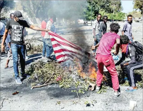  ?? AFP ?? Protesters burn a US flag on Sunday in Port-au-Prince, Haiti to demand the resignatio­n of president Jovenel Moïse, who seeks to extend his term of office until February next year, which according to the constituti­on ends this February 7.