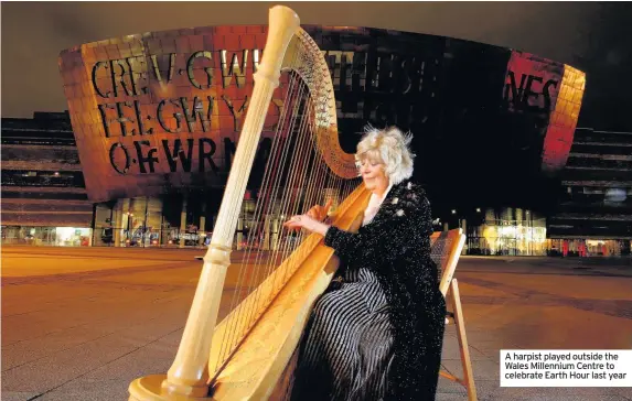  ??  ?? A harpist played outside the Wales Millennium Centre to celebrate Earth Hour last year