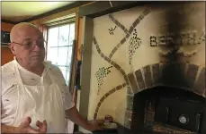  ?? JANET PODOLAK — THE NEWS-HERALD ?? Patrick Vautrin shows off Bertha, the hand-built wood-fired brick oven he constructe­d for baking breads at his La Crust.