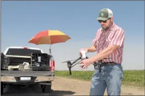  ?? AP/ SCOTT SMITH ?? Danny Royer prepares to pilot a drone over a tomato fi eld last month near Los Banos, Calif., to search for leaks in a farm’s irrigation system. Thousands of would- be drone operators are expected to take a federal licensing exam for commercial...