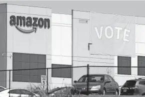  ?? JAY REEVES/AP ?? A banner encouragin­g workers to vote in labor balloting hangs at an Amazon warehouse in March in Bessemer, Ala.