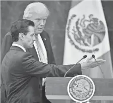  ?? YURI CORTEZ, AFP/GETTY IMAGES ?? Donald Trump and Mexican President Enrique Peña Nieto prepare for a news conference in Mexico City on Wednesday.