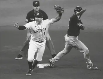  ?? KEVIN M. COX/AP ?? HOUSTON ASTROS SHORTSTOP CARLOS CORREA CELEBRATES after catching Boston Red Sox’s Alex Verdugo trying to steal second base during the seventh inning of Game 6 of the AL Championsh­ip Series Friday in Houston.