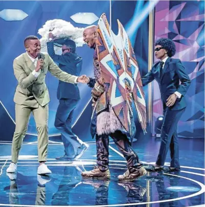  ?? /SUPPLIED ?? The Masked Singer SA host Mpho Popps welcomes political leader Mmusi Maimane after he was unveiled as the Warrior on music show.