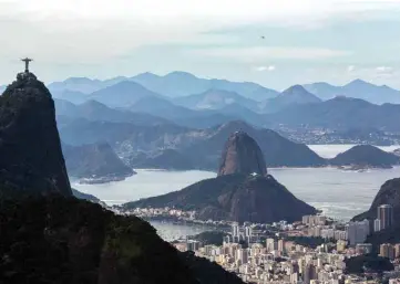  ??  ?? The Christ Redeemer statue and the Sugar Loaf hill are seen from a hiking trail part of a projected 8,000kilomet­er trail across Brazil.