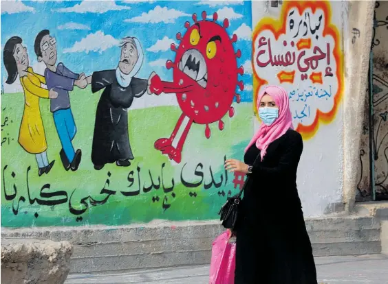  ?? Photo / AP ?? A coronaviru­s mural in Nusseirat refugee camp in the central Gaza Strip reads: “Protect yourself, together we protect the old.”