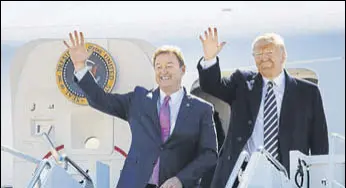  ??  ?? US President Donald Trump arrives with Nevada Senator Dean Heller, on Air Force One, at the Elko Regional Airport, on Saturday.