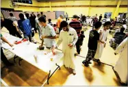  ?? JAY REEVES ?? In this Thursday, photo, Muslims at Champions Mosque gather for a meal at an Islamic holy day celebratio­n. Houston's Muslim community, an estimated 200,000 people, has opened many of its community centers and sent hundreds of volunteers to serve food...