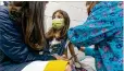  ?? SHAWN ROCCO / DUKE HEALTH ?? Alejandra Gerardo, 9, looks up to her mom, Dr. Susanna Naggie, as she gets the first of two Pfizer COVID-19 vaccinatio­ns during a clinical trial for children Wednesday at Duke Health in Durham, N.C.