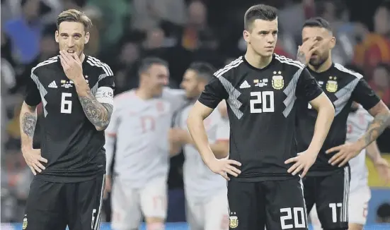  ??  ?? 2 Argentina’s Lucas Biglia, Giovani Lo Celso and Nicolas Otamendi look stunned after Spain’s sixth goal during Tuesday night’s friendly at the Wanda Metropolit­ano Stadium in Madrid.
