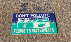  ?? Commercial/Byron Tate) ?? Small signs like this one remind the public that anything that goes down an outside drain flows directly into the waterway and can pollute streams and rivers. (Pine Bluff