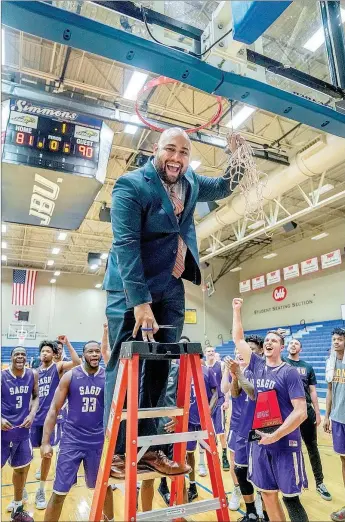  ?? Matthew Christense­n/JBU Sports Informatio­n ?? First-year Southweste­rn Assemblies of God coach Delton Deal holds up the freshly trimmed basketball net after the Lions defeated Wayland Baptist 90-81 on Saturday in the Sooner Athletic Conference Tournament men’s championsh­ip at Bill George Arena on...