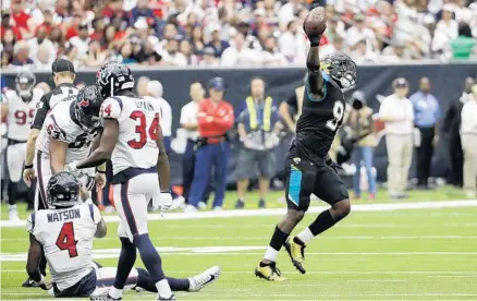  ?? DAVID J. PHILLIP/ASSOCIATED PRESS ?? Jags DE Yannick Ngakoue comes away with a fumble on a day when the defense had a franchise-record 10 sacks and dominated the Texans’ offense.